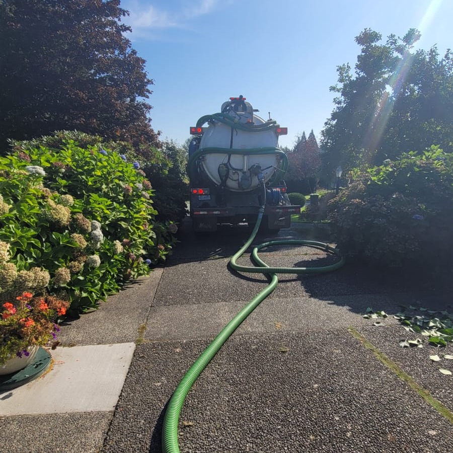 Clearset vacuum truck staged on a residential driveway for an on-site pump-out stop.