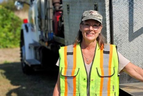 Clearset crew member beside a service truck during an on-site service stop.